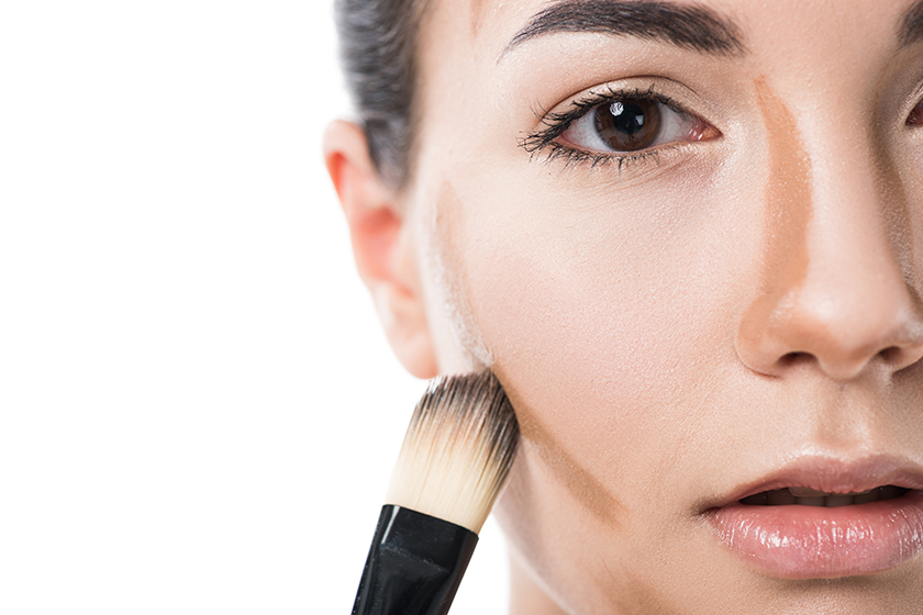 cropped image of beautiful girl applying foundation cream with b